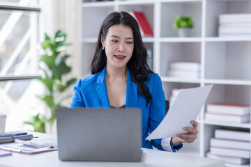 Business asian woman working at office with documents on his desk, doing planning analyzing the financial report, business plan investment, finance analysis concept