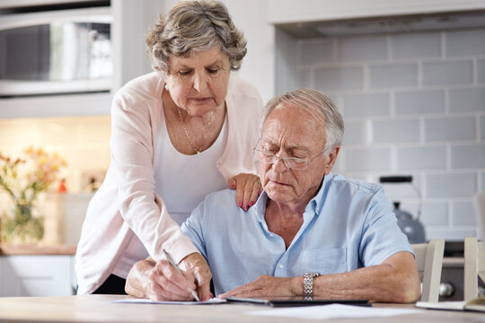 Loud Like Love. An Elderly Couple Going Over Paperwork At Home.