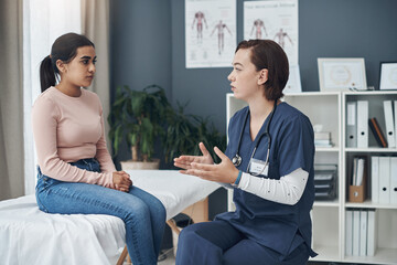 This is what you need to do. a young female doctor talking to a patient in an office.