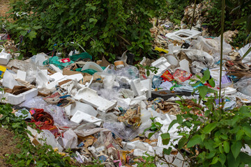 01-05-2023, Narendrapur, West Bengal, India: Large pile of garbage dumped at the side of the road with plastic container and paper boxes.