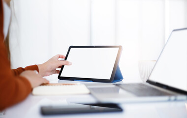 Asian teenage woman study online class at home or cafe by using tablet and laptop, video call with teacher and friends learning, university student studying online concept
