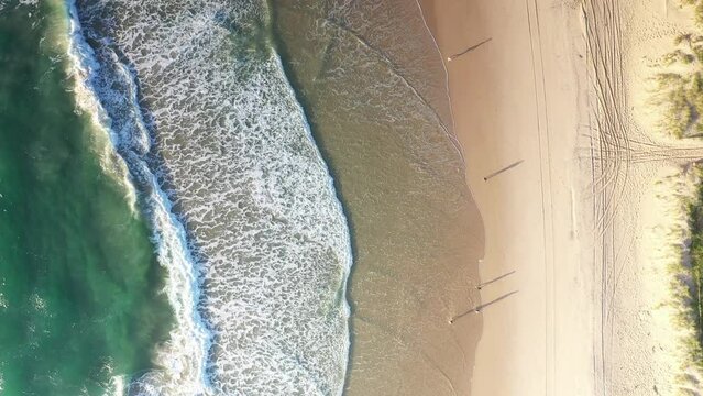 Aerial top down following beach coastline at sunrise, Gold Coast Australia