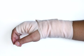 Man hand with painful wrist due to overuse or sport accidental and strapping by elastic bandage for...