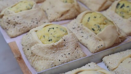 Fresh, raw Flaouna pastries ready and waiting to be baked.
