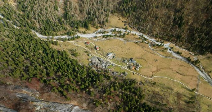 Aerial view of a quaint village community in the middle of valley of Val di Mello Natural Reserve during summertime.
