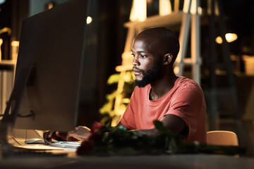 All they need from you is dedication. a business man using his computer while working late at the office.