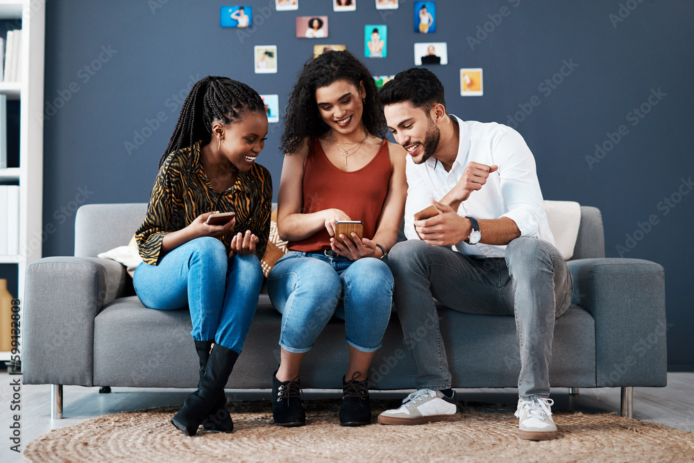 Poster I thought of you both when I saw this. Full length shot of a diverse group of business colleagues sitting on a sofa together and using a cellphone.