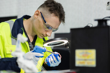 man electrical engineer using solder repairing instrument cable microchip board. repairman worker...