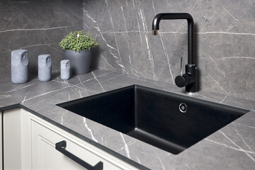 Single handle water kitchen faucet built in compact high pressure laminate HPL countertop. Kitchen undermount installation granite composite sink.