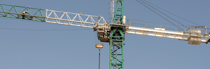 Fototapeta na wymiar tower cranes at construction site and city background