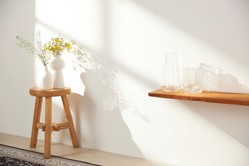 Vases and objects on the table in a warm room with sunlight coming in