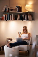 Connected while still relaxing at home - Internet access. Attractive young woman using her laptop...