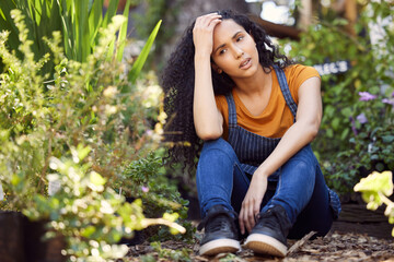 Everyone needs a break from time to time. a young female florist suffering from a headache at work.