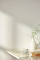 Vases and objects on the table in a warm room with sunlight coming in