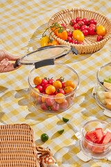 Various vegetables and fruits in glass crisper, outdoor grass camping scene, healthy lifestyle