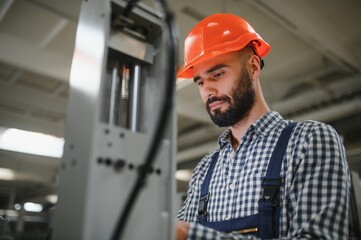 modern industrial machine operator working in factory