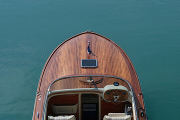 Front deck Luxurious lacquered wooden big boat on the water top view. - obrazy, fototapety, plakaty