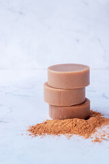 stack of oat milk moroccan red clay handmade natural soap bars on white marble background.