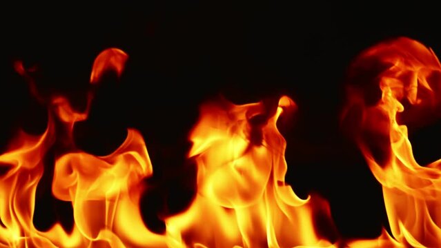 Slow motion video of fire and flames burning gas or gasoline ignited by fire and flames.