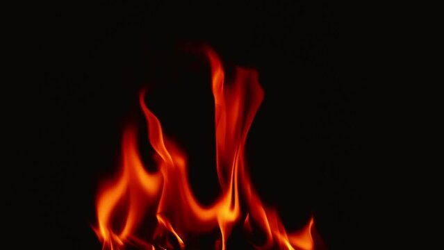 Slow motion video of fire and flames burning gas or gasoline ignited by fire and flames.