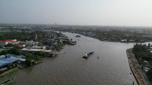 Drone footage above the Mekong in Cai Rang district, Can Tho, Mekong delta Vietnam. Camera is filming boat activities on the river