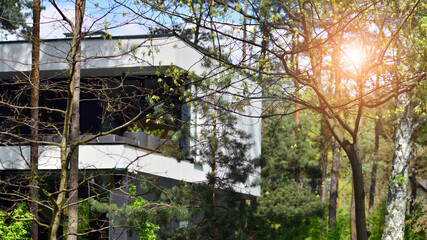 Fototapeta na wymiar Upscale house in wooded area. Fragment of a single-family house facade. 