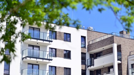 Modern apartment buildings on a sunny day with a blue sky. Facade of a modern apartment building. Contemporary residential building exterior in the daylight. 