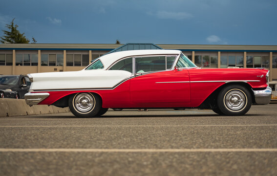 Oldsmobile standing in a parking lot. Beautiful vintage Oldsmobile 1957 Super 88 Coupe.