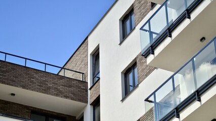 Modern apartment buildings on a sunny day with a blue sky. Facade of a modern apartment building. Contemporary residential building exterior in the daylight. 