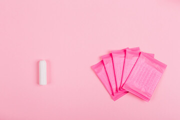 Daily sanitary tampon and pads for special critical days on pink background. Copy space. Secrets of...