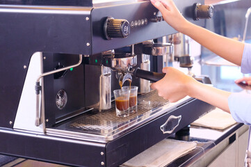 Young female employees making fresh coffee coffee shop concept.