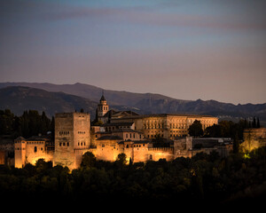 Illumination of the Alhambra in Granada at nightfall - obrazy, fototapety, plakaty