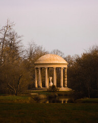 temple of love with sculpture of cupid in field of Versailles