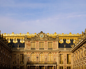 Entrance to the Palace of Versailles illuminated by the sun at dawn