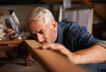 Carpenter, construction and senior man with wood project, thinking and checking with development....