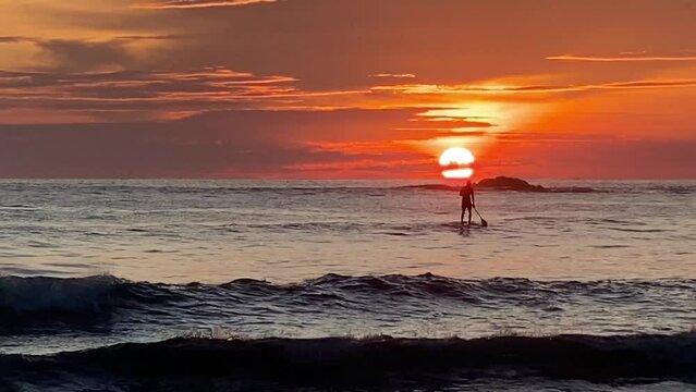 Lonely peddleboard at dramatic sunset, Costa Rica