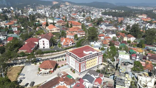 Aerial footage above Dalat city, south Vietnam and old french colonial houses. Camera is moving foward 1-2