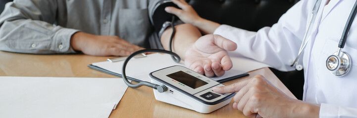 Doctor checking  patient arterial blood pressure. Health care