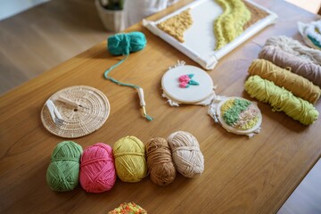 Punch needle. Asian Woman making handmade Hobby knitting in studio workshop. designer workplace Handmade craft project DIY embroidery concept.