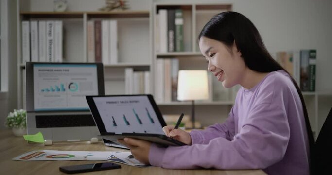 Footage of young Asian woman, freelance data scientist work remotely at home coding programming on Big data mining, AI data engineering, Female writes notes on tablet. IT Technician. Telework concept.