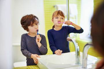 Children brushing teeth in home bathroom with toothbrush for hygiene and clean mouth. Oral healthcare or fresh breath, kids grooming while bonding and wellness with dental care at sink for dentist - Powered by Adobe
