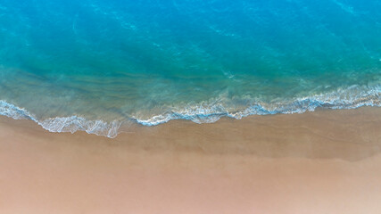 Aerial view with beach in wave of turquoise sea water shot, Top view of beautiful white sand background