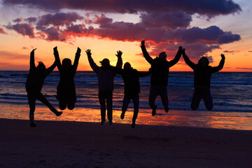 Beach, sunset and silhouette of jumping friends in nature, freedom and celebrating travel outdoor....