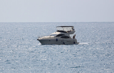 The yacht floats on the waves of the sea