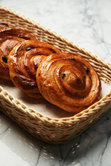 Baked pain aux raisins. Puff pastry bun with raisin