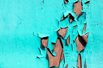 Old peeling paint on blue metal.