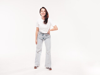 Young beautiful woman. Trendy carefree model in casual summer white T-shirt and blue jeans. Positive female isolated on white in studio. Cheerful and happy. Copy space, mockup. full length