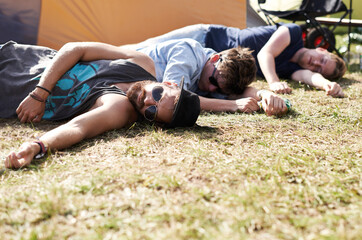 Drunk sleeping, hangover and party people on camping park at music festival with alcohol. Field,...