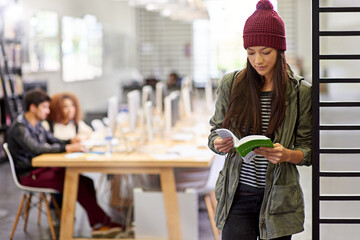 Woman, student in library reading book and study for exam or research for project on university...