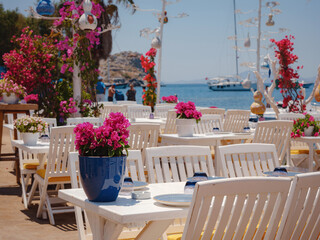 Bodrum summer travel to Turkey. Aegean fish restaurant table in Gumusluk Town, Bodrum, Turkey. Restaurant tables and chairs are in the sea